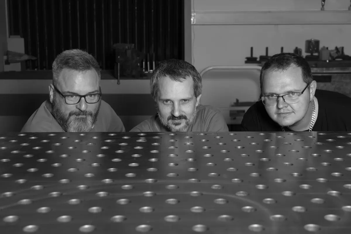 Michal Benda (centre), Kamil Hrbáček and Martin Olík on the PhotoRobot production floor in Prague